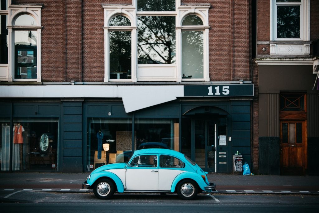 Pale blue classic VW Beetle parked by the roadside